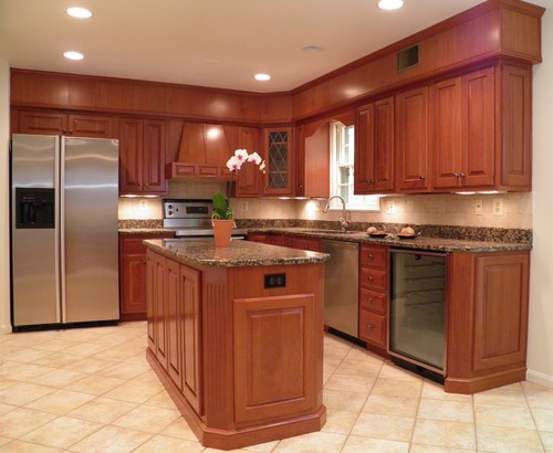 Baltic Brown Granite Countertop and Baltic Brown Island Top, Sunset Stained Cherry Cabinets, Beige Tumbled Marble Square Backsplash, Diagonal Set Up Travertine Flooring and Stainless Steel Appliance